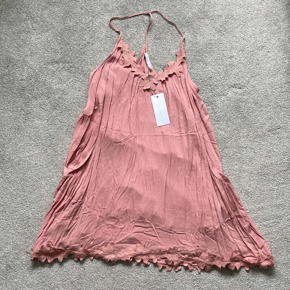 Lush coral pink halter mini dress with flower trim. new with tags. Size medium.